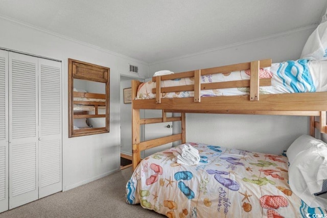4305 S Ocean Blvd Unit 106, North Myrtle Beach, SC 29582 - carpeted bedroom with ornamental molding, a closet, and a textured ceiling