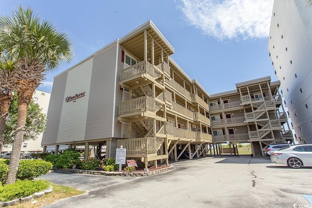 view of building exterior with uncovered parking