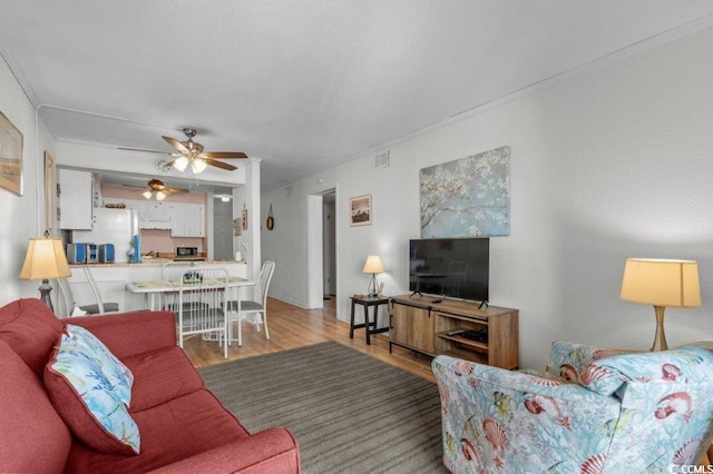 4305 S Ocean Blvd Unit 106, North Myrtle Beach, SC 29582 - living area with wood finished floors, ceiling fan, and crown molding