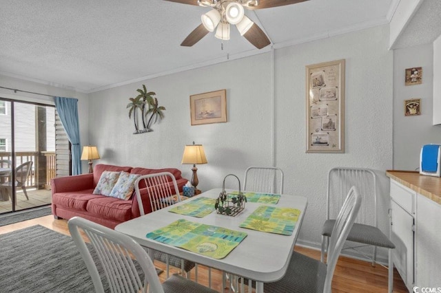 4305 S Ocean Blvd Unit 106, North Myrtle Beach, SC 29582 - dining space featuring wood finished floors, a textured wall, ceiling fan, ornamental molding, and a textured ceiling