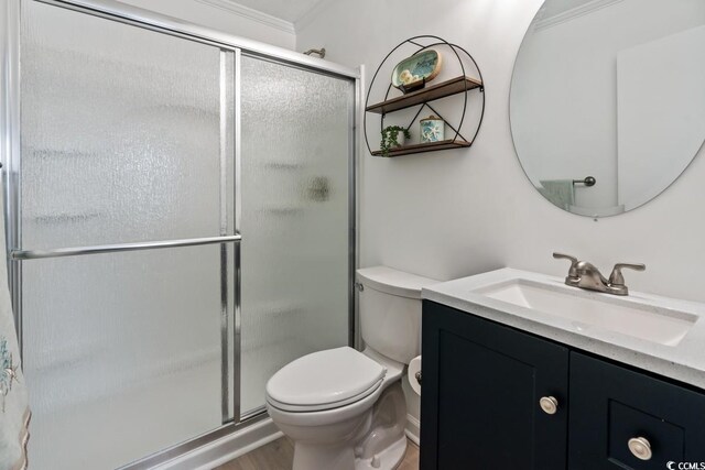 6001 N Ocean Blvd Unit 242, North Myrtle Beach, SC 29582 - bathroom with vanity, toilet, a shower with shower door, and crown molding