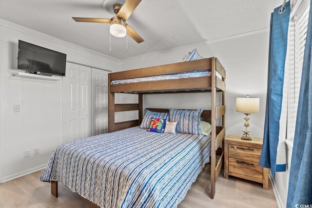 6001 N Ocean Blvd Unit 242, North Myrtle Beach, SC 29582 - bedroom featuring ceiling fan, a closet, ornamental molding, and hardwood / wood-style flooring