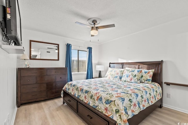 6001 N Ocean Blvd Unit 242, North Myrtle Beach, SC 29582 - bedroom featuring light wood-style flooring, a textured ceiling, and ceiling fan