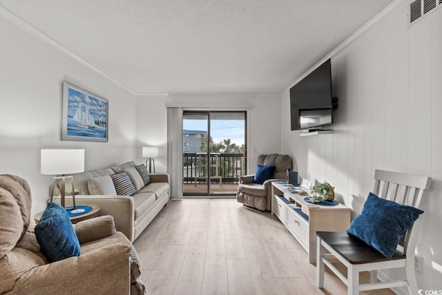 6001 N Ocean Blvd Unit 242, North Myrtle Beach, SC 29582 - living area featuring light wood-style flooring, crown molding, and a textured ceiling