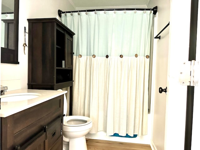 full bathroom featuring shower / tub combo, hardwood / wood-style flooring, toilet, and vanity