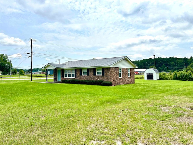 single story home with a front yard and a shed