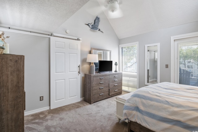 bedroom with a textured ceiling, a barn door, light carpet, high vaulted ceiling, and ceiling fan