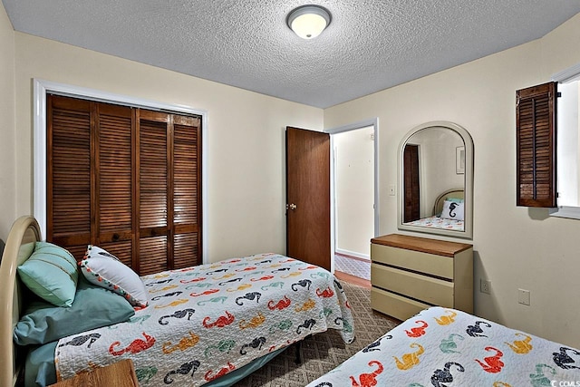 carpeted bedroom featuring a textured ceiling and a closet