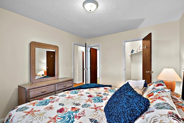 bedroom with a textured ceiling and a closet