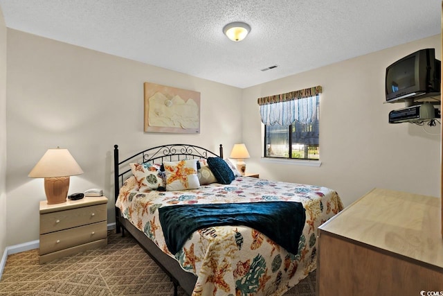 carpeted bedroom featuring a textured ceiling