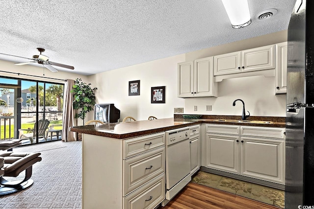 kitchen featuring hardwood / wood-style floors, sink, kitchen peninsula, and ceiling fan