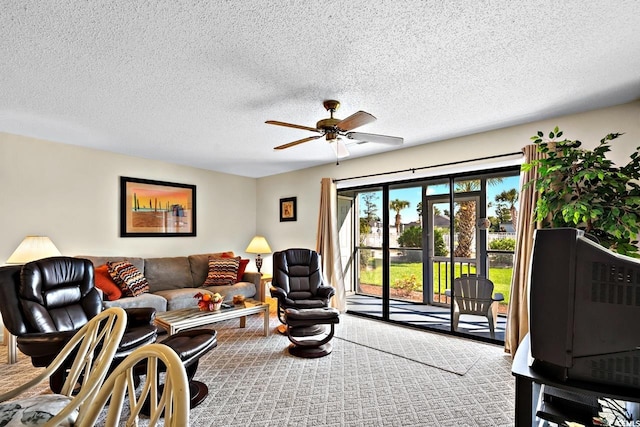 carpeted living room with a textured ceiling and ceiling fan