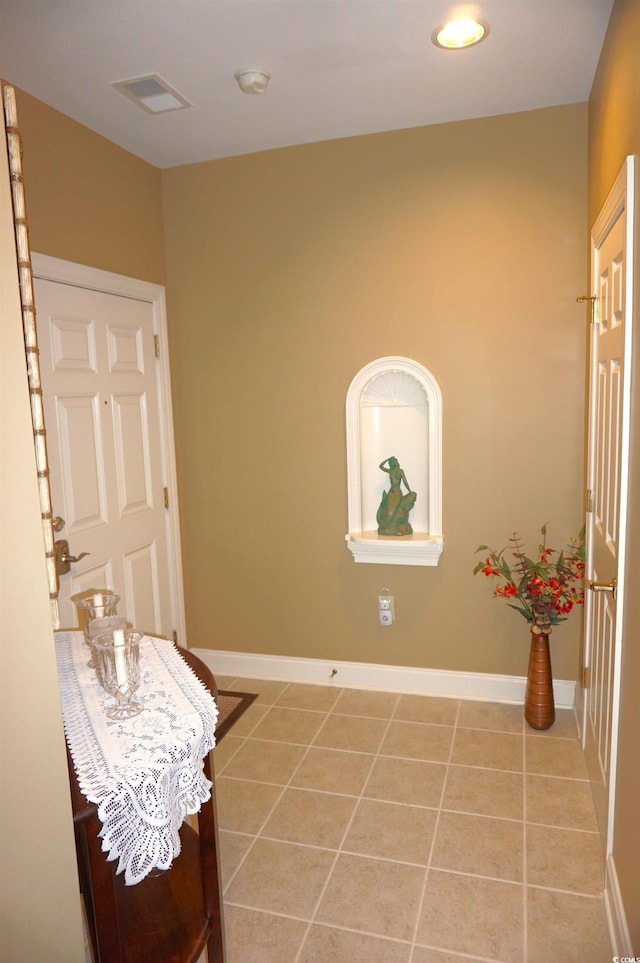 hall featuring tile patterned flooring