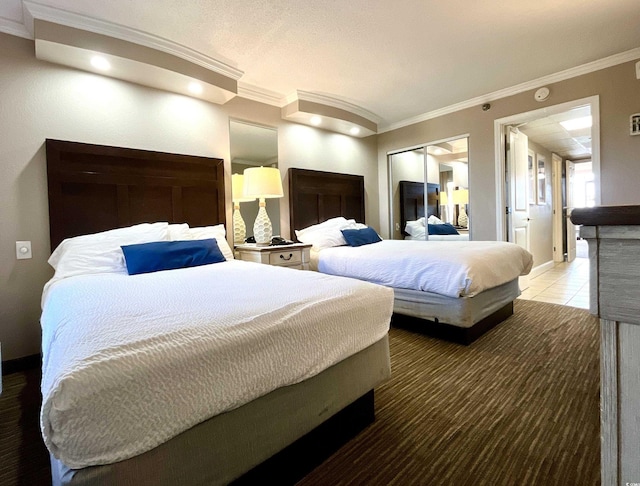 bedroom featuring tile patterned flooring, a closet, and crown molding