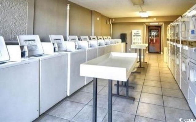 interior space with light tile patterned floors and washing machine and dryer