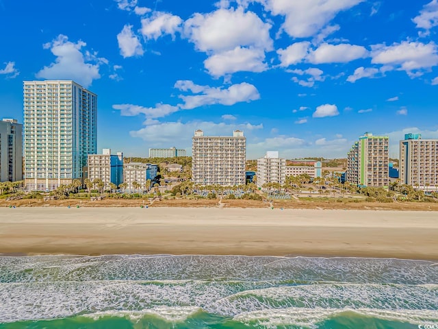 surrounding community featuring a beach view and a water view