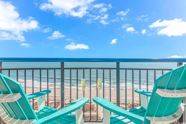 balcony featuring a water view and a view of the beach