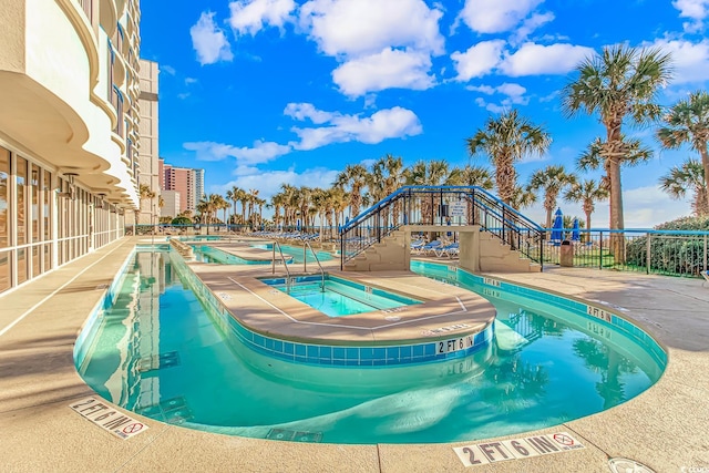 view of swimming pool featuring a community hot tub