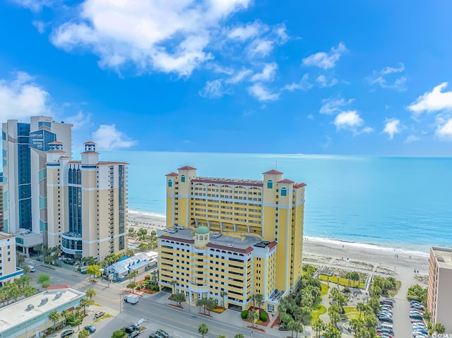 drone / aerial view featuring a water view and a view of the beach