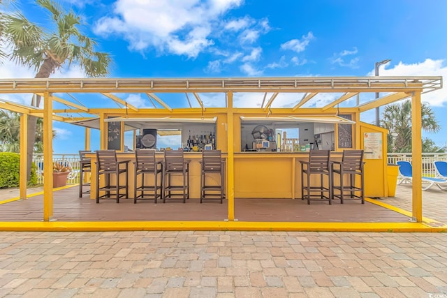 view of patio / terrace featuring exterior bar and a wooden deck