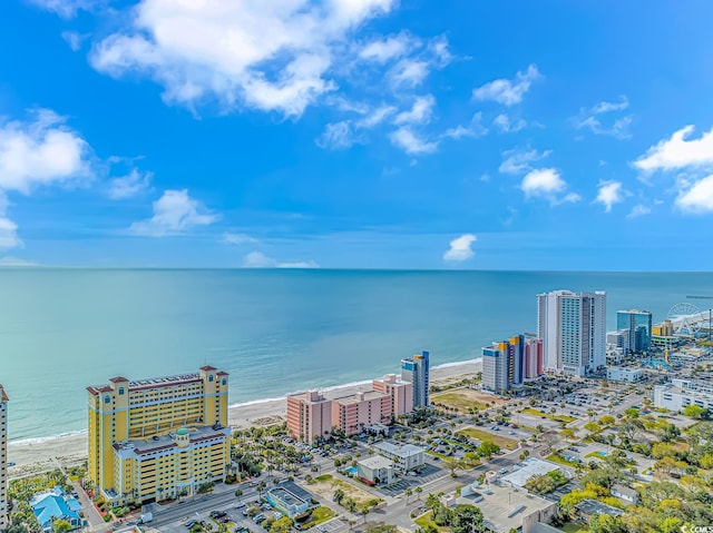 drone / aerial view featuring a beach view and a water view