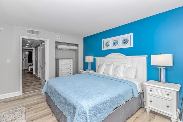 bedroom featuring a closet and light hardwood / wood-style flooring