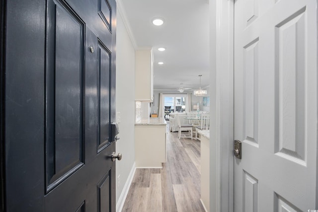 entrance foyer with crown molding, light wood-style flooring, and recessed lighting