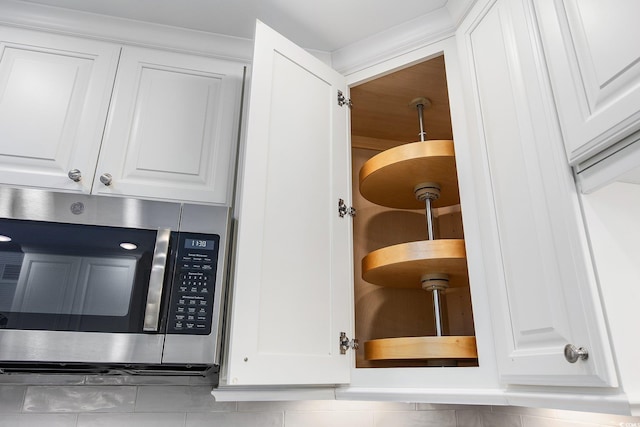 interior details with stainless steel microwave and white cabinets