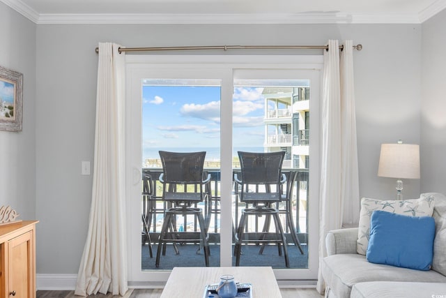 interior space featuring a healthy amount of sunlight, crown molding, and baseboards