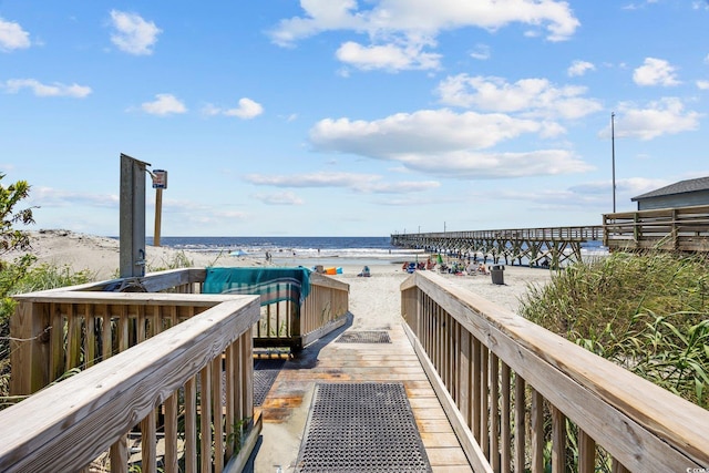 view of home's community featuring a water view and a view of the beach