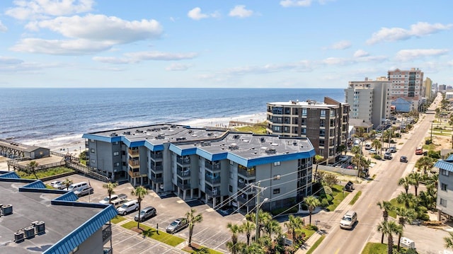 birds eye view of property featuring a water view and a city view