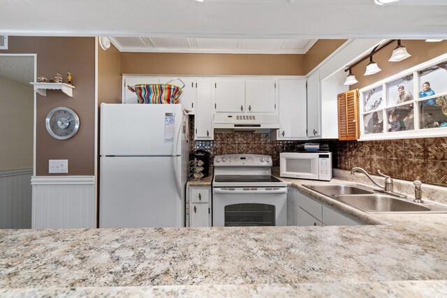 kitchen featuring sink, ornamental molding, white appliances, tasteful backsplash, and white cabinetry