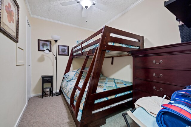 bedroom with ceiling fan, a textured ceiling, and light carpet