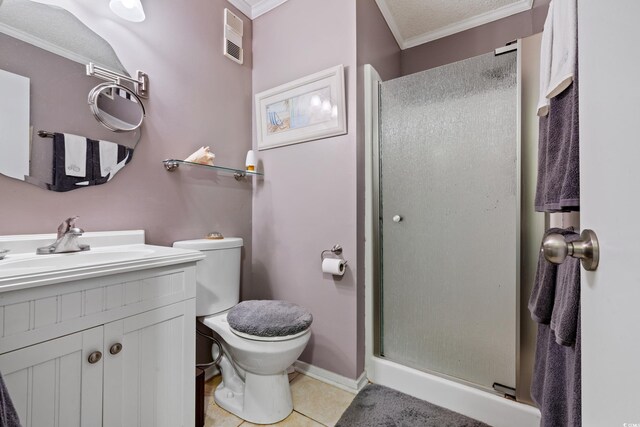 bathroom with a shower with door, toilet, vanity, tile patterned floors, and crown molding