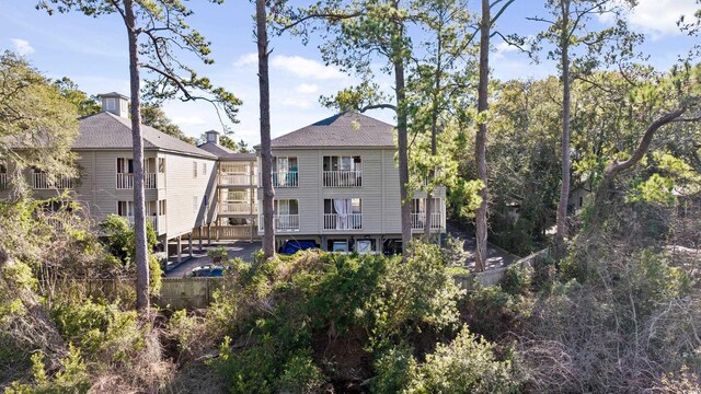 back of property featuring a balcony