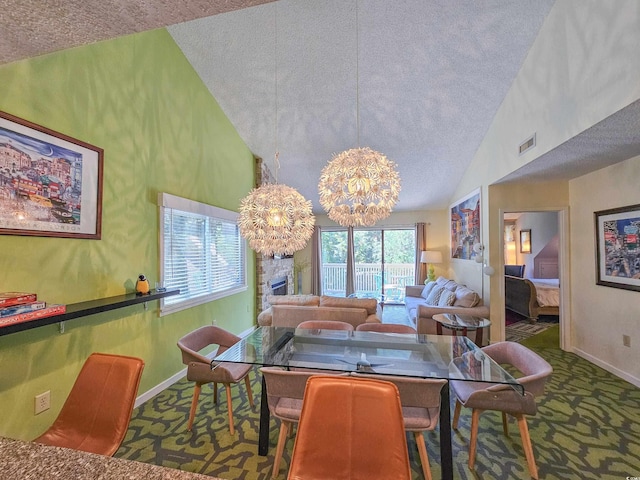 carpeted dining area with a textured ceiling, high vaulted ceiling, and a notable chandelier