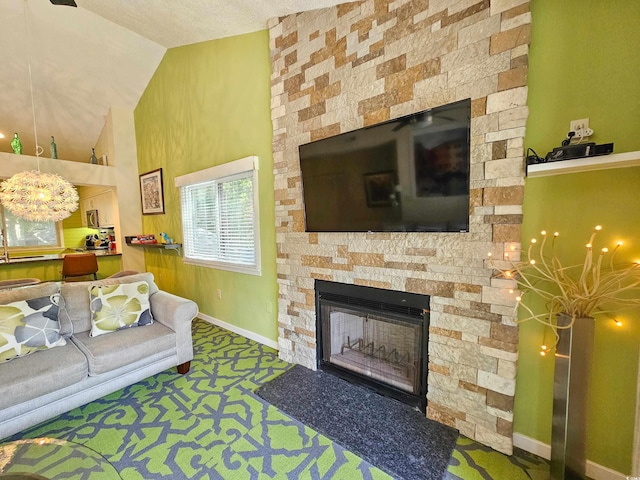 carpeted living room with a fireplace, vaulted ceiling, and a textured ceiling