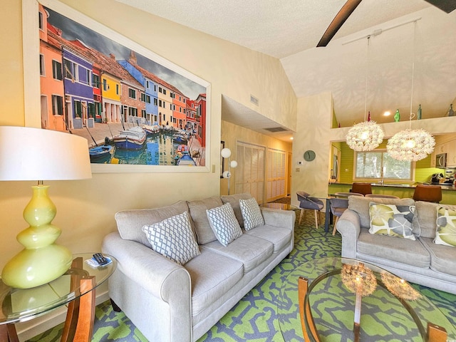 living room with a notable chandelier, visible vents, vaulted ceiling, and a textured ceiling