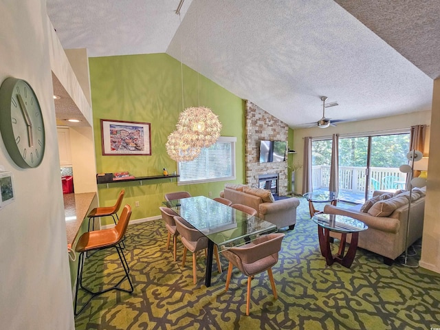 carpeted living area featuring a ceiling fan, a large fireplace, vaulted ceiling, a textured ceiling, and baseboards