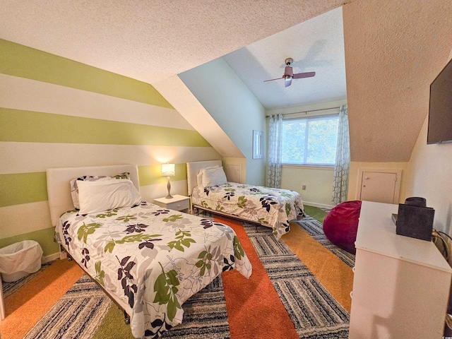 carpeted bedroom with ceiling fan, a textured ceiling, and lofted ceiling