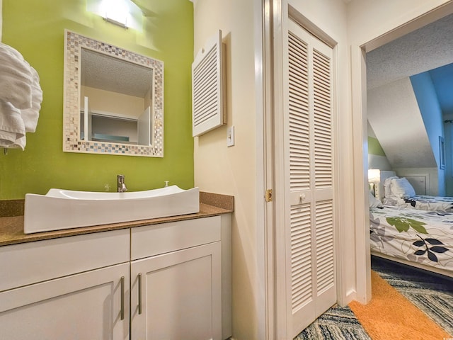 bathroom with a textured ceiling and vanity