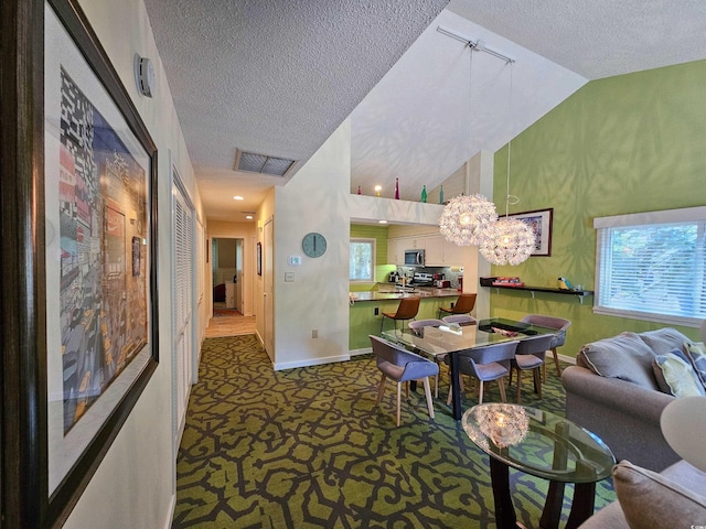 living room with baseboards, visible vents, an inviting chandelier, a textured ceiling, and carpet flooring