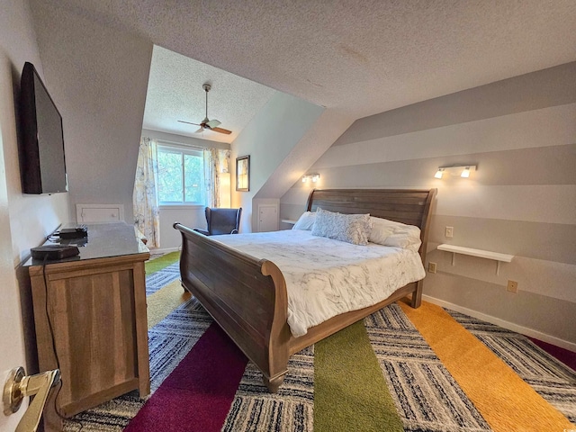 bedroom with ceiling fan, carpet, and a textured ceiling