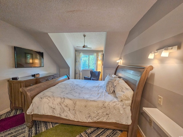 carpeted bedroom featuring a textured ceiling and lofted ceiling