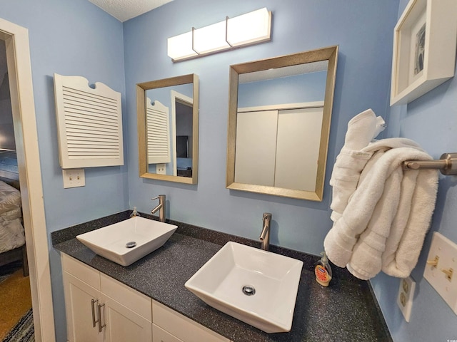 bathroom featuring double vanity and a sink