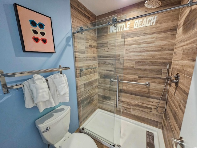 bathroom with visible vents, a stall shower, and toilet