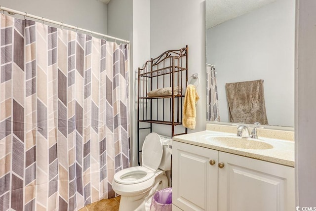 bathroom with tile patterned floors, a shower with curtain, vanity, and toilet