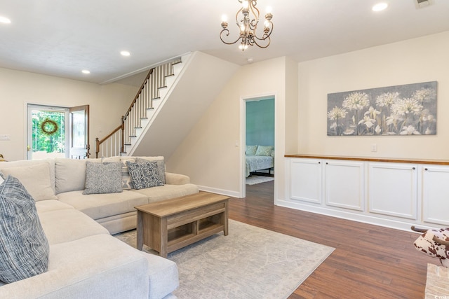 living room featuring stairway, baseboards, dark wood finished floors, an inviting chandelier, and recessed lighting