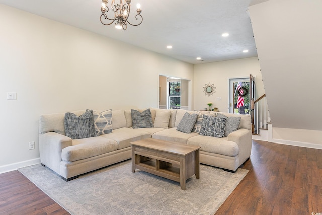 living area with wood finished floors, baseboards, an inviting chandelier, recessed lighting, and stairs