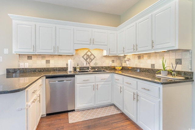 kitchen with stainless steel dishwasher, white cabinets, wood finished floors, and a sink